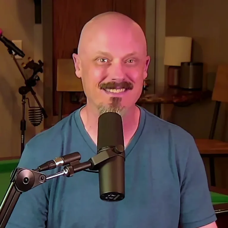 Joe Watkins smiling at the mic in the FIBERS studio, blue shirt